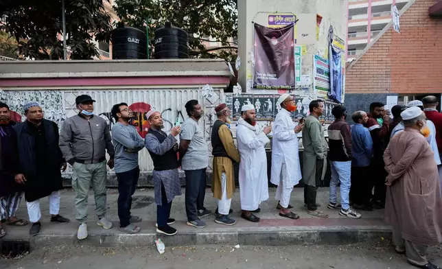 Bangladeshi people stand in queue to cast their votes in a polling station during national parliamentary election in Dhaka, Bangladesh, Thursday, Feb. 12, 2026. (AP Photo/Anupam Nath)
