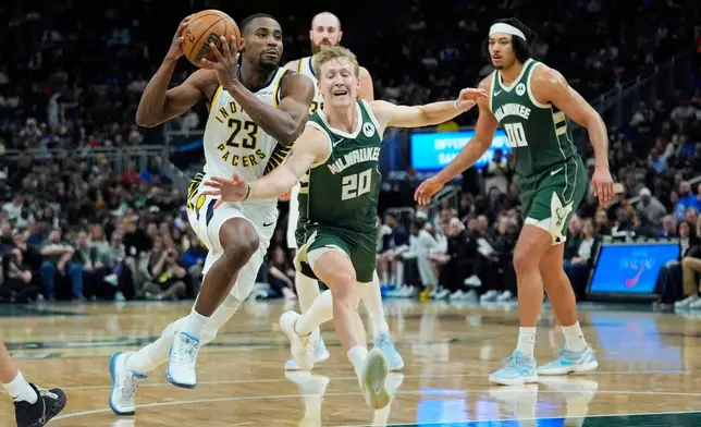 Indiana Pacers' Aaron Nesmith (23) drives to the basket against Milwaukee Bucks' AJ Green (20) during the first half of an NBA basketball game Friday, Feb. 6, 2026, in Milwaukee. (AP Photo/Aaron Gash)