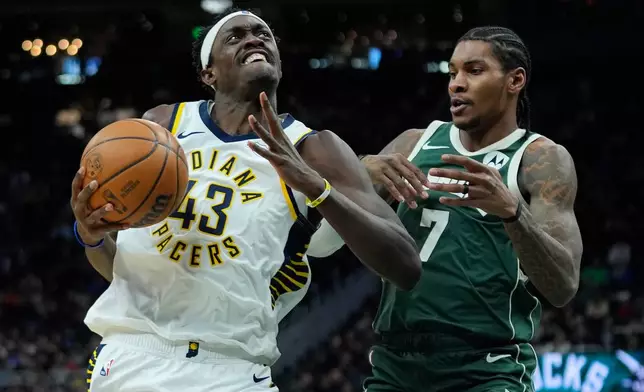 Indiana Pacers' Pascal Siakam (43) drives to the basket against Milwaukee Bucks' Kevin Porter Jr. (7) during the first half of an NBA basketball game Friday, Feb. 6, 2026, in Milwaukee. (AP Photo/Aaron Gash)