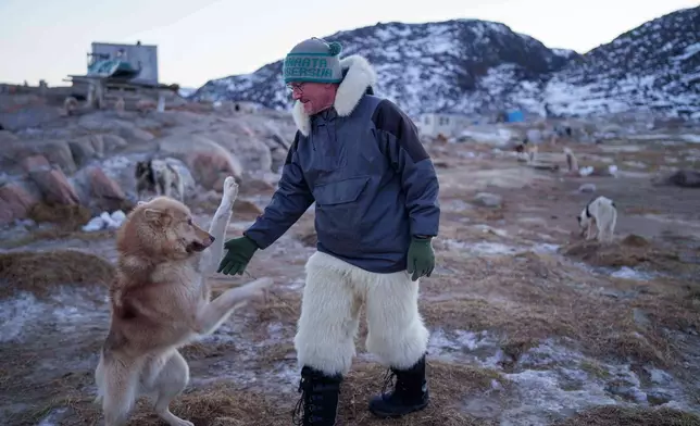 Jørgen Kristensen pets his sled dog before a ride in Ilulissat, Greenland, Tuesday, Jan. 27, 2026. (AP Photo/Evgeniy Maloletka)