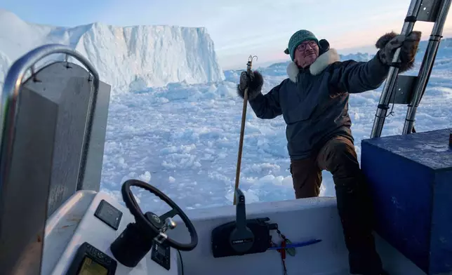Jørgen Kristensen gets on a boat by an iceberg at Disko Bay near Ilulissat, Greenland, Thursday, Jan. 29, 2026. (AP Photo/Evgeniy Maloletka)