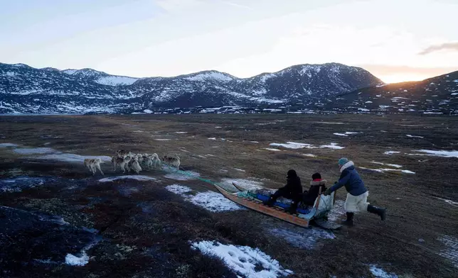 Jørgen Kristensen rides with his sled dogs in Ilulissat, Greenland, Tuesday, Jan. 27, 2026. (AP Photo/Evgeniy Maloletka)