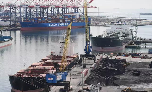Ships are docked at the Port of Long Beach Friday, Feb. 20, 2026, in Long Beach, Calif. (AP Photo/Damian Dovarganes)