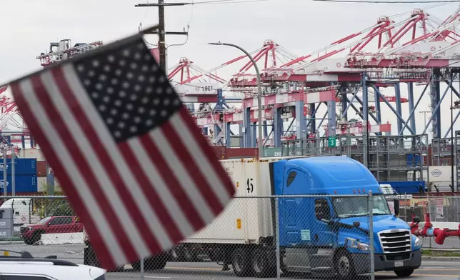 A U.S. flag files at the Port of Long Beach Friday, Feb. 20, 2026, in Long Beach, Calif. (AP Photo/Damian Dovarganes)