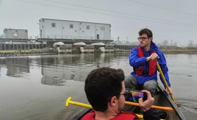 Andrew Ferris, executive director of the Coalition to Restore Coastal Louisiana, paddles out to a wetland restoration site Friday, Jan. 23, 2026, in Meraux, La. (AP Photo/Joshua A. Bickel)