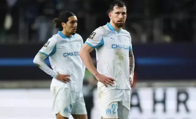 Marseille's Pierre-Emile Hojbjerg, center, reacts after Paris FC's Ilan Kebbal scoring from the penalty spot during the French League One soccer match between Paris FC and Marseille in Paris, Saturday, Jan. 31, 2026. (AP Photo/Thibault Camus)