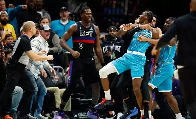 Charlotte Hornets forward Moussa Diabate is held back as he fights with Detroit Pistons center Jalen Duren (0) during the second half of an NBA basketball game in Charlotte, N.C., Monday, Feb. 9, 2026. (AP Photo/Nell Redmond)
