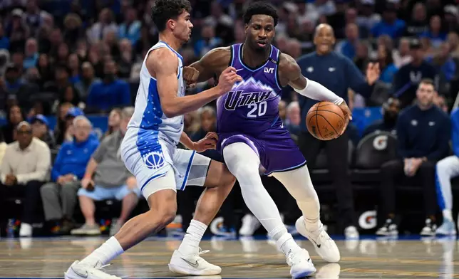 Utah Jazz center Jaren Jackson Jr. (20) is defended by Orlando Magic forward Tristan da Silva, left, during the first half of an NBA basketball game, Saturday, Feb. 7, 2026, in Orlando, Fla. (AP Photo/Phelan M. Ebenhack)