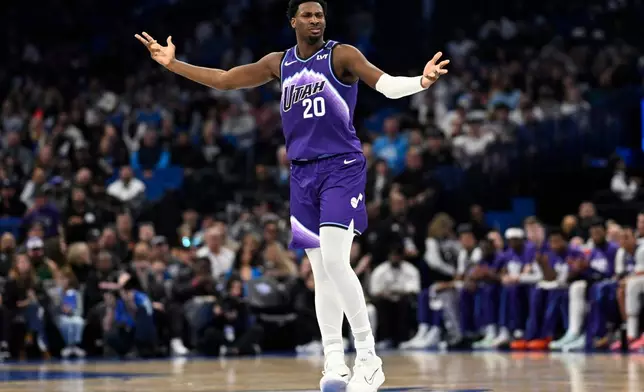 Utah Jazz center Jaren Jackson Jr. (20) reacts after scoring a 3-point basket against the Orlando Magic during the first half of an NBA basketball game, Saturday, Feb. 7, 2026, in Orlando, Fla. (AP Photo/Phelan M. Ebenhack)