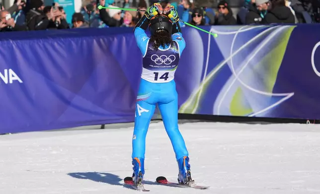 Italy's Federica Brignone celebrates at the finish area of an alpine ski, women's giant slalom race, at the 2026 Winter Olympics, in Cortina d'Ampezzo, Italy, Sunday, Feb. 15, 2026. (AP Photo/Jacquelyn Martin)
