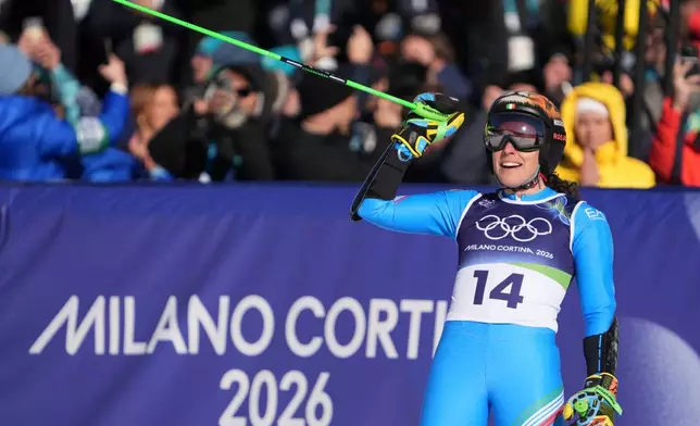 Italy's Federica Brignone celebrates at the finish area of an alpine ski, women's giant slalom race, at the 2026 Winter Olympics, in Cortina d'Ampezzo, Italy, Sunday, Feb. 15, 2026. (AP Photo/Jacquelyn Martin)