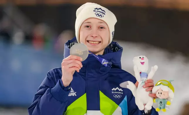 Nika Prevc, of Slovenia, poses after winning the silver medal in the ski jumping women's normal hill individual, at the 2026 Winter Olympics, in Predazzo, Italy, Saturday, Feb. 7, 2026. (AP Photo/Kirsty Wigglesworth)