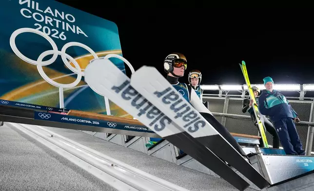 Domen Prevc, of Slovenia, takes his position on the ramp for a jump during a ski jumping, men's normal hill, training session, at the 2026 Winter Olympics, in Predazzo, Italy, Sunday, Feb. 8, 2026. (AP Photo/Matthias Schrader)