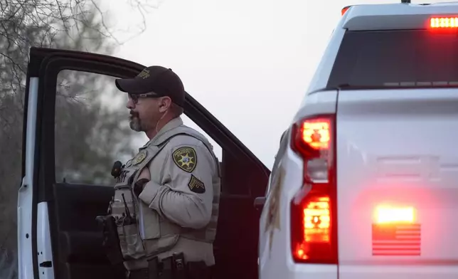 A member of the Pima County sheriffs office stands by his truck looking at Nancy Guthrie‘s house, Monday, Feb. 9, 2026 in Tucson, Ariz. (AP Photo/Ty ONeil)