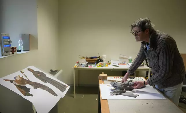 Massimiliano Trubbiani, an expert in tactile education for blind and visually impaired people, works to transform Titian's Pala Gozzi into bas-relief in a laboratory at the Omero Tactile Museum in Ancona, Italy, Friday, Jan. 16, 2026. (AP Photo/Alessandra Tarantino)