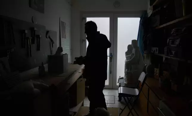 Felice Tagliaferri, a blind sculptor, stands in his studio in Cesena, Italy, Friday, Jan. 16, 2026. (AP Photo/Alessandra Tarantino)