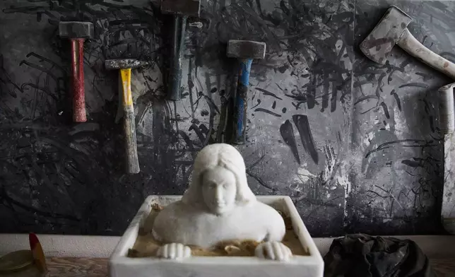Powder covers the hammers of Felice Tagliaferri, a blind sculptor, in his studio in Cesena, Italy, Friday, Jan. 16, 2026. (AP Photo/Alessandra Tarantino)