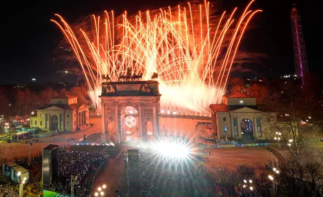Fireworks illuminate the sky after Italian former skier Deborah Compagnoni and Italian former skier Alberto Tomba lit the cauldron at the Arco della Pace during the Olympic opening ceremony at the 2026 Winter Olympics, in Milan, Italy, Friday, Feb. 6, 2026. (AP Photo/Luca Bruno)