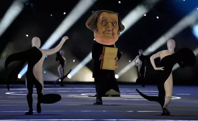 Dancers perform during the Olympic opening ceremony at the 2026 Winter Olympics, in Milan, Italy, Friday, Feb. 6, 2026. (AP Photo/Ashley Landis)