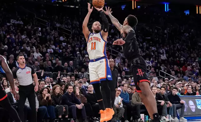 New York Knicks guard Jalen Brunson (11) shoots over Houston Rockets forward Jabari Smith Jr. (10) during the second half of an NBA basketball game, Saturday, Feb. 21, 2026, in New York. (AP Photo/Yuki Iwamura)