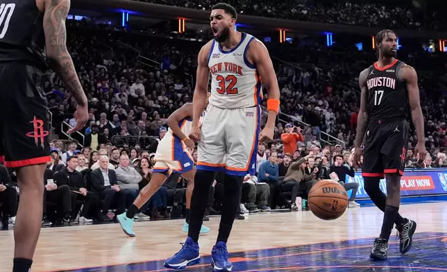 New York Knicks center Karl-Anthony Towns (32) reacts after scoring during the second half of an NBA basketball game against the Houston Rockets, Saturday, Feb. 21, 2026, in New York. (AP Photo/Yuki Iwamura)