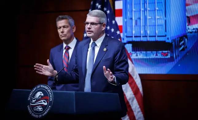 Federal Motor Carrier Safety Administrator Derek Barrs speaks beside U.S. Transportation Secretary Sean Duffy, left, during a news conference on enhancing truck driving safety at the U.S. Department of Transportation on Friday, Feb. 20, 2026, in Washington. (AP Photo/Tom Brenner)