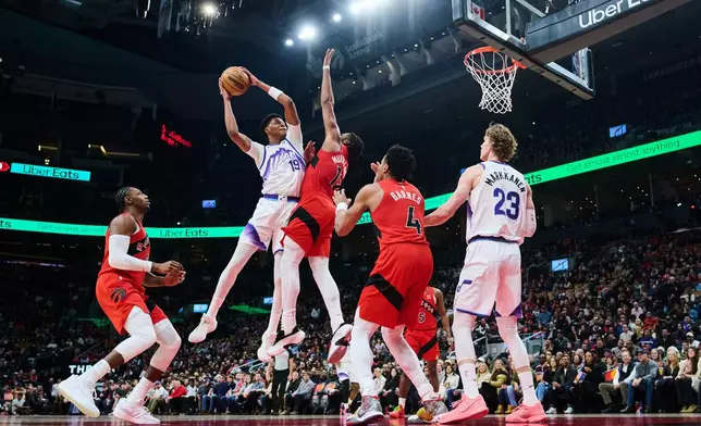 Utah Jazz's Ace Bailey (19) is blocked on a drive to the net by Toronto Raptors' Collin Murray-Boyles (12) during the first half of an NBA basketball game in Toronto, Sunday, Feb. 1, 2026. (Sammy Kogan/The Canadian Press via AP)