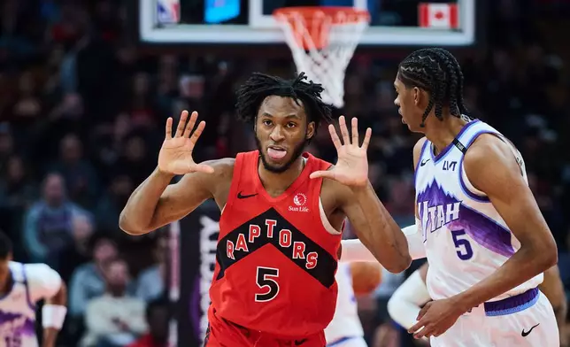 Toronto Raptors' Immanuel Quickley (5) reacts after a 3-point basket against the Utah Jazz during first-half NBA basketball game action in Toronto, Sunday, Feb. 1, 2026. (Sammy Kogan/The Canadian Press via AP)