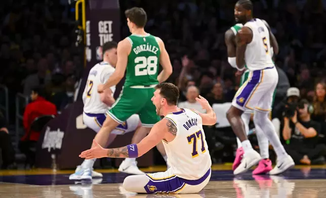 Los Angeles Lakers guard Luka Doncic reacts on the court during the first half of an NBA basketball game against the Boston Celtics Sunday, Feb. 22, 2026, in Los Angeles. (AP Photo/Katie Chin)