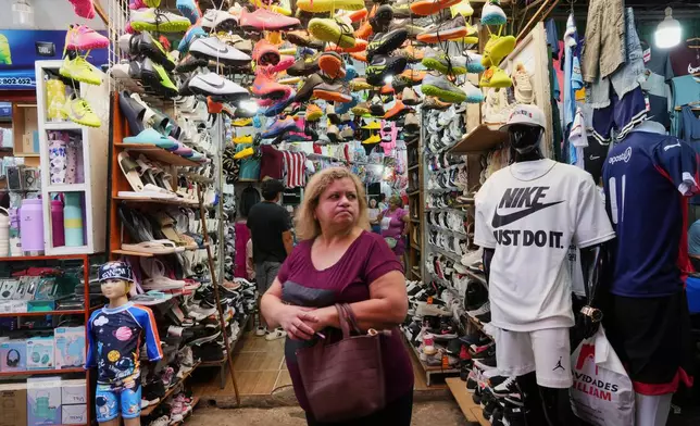 A woman shops at a store that primarily sells sports clothing imported from China in Asuncion, Paraguay, Saturday, Jan. 31, 2026. (AP Photo/Jorge Saenz)