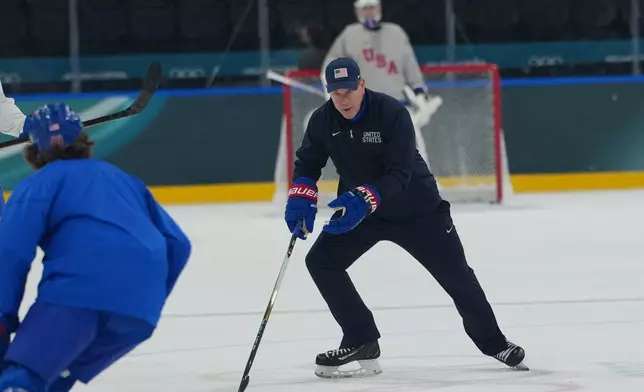 United States' head coach Mike Sullivan skies with the puck during men's ice hockey practice at the 2026 Winter Olympics, in Milan, Italy, Sunday, Feb. 8, 2026. (AP Photo/Carolyn Kaster)