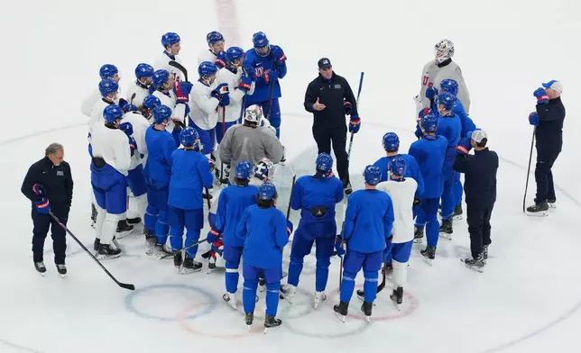 United States' head coach Mike Sullivan, center, speaks to his team during men's ice hockey practice at the 2026 Winter Olympics, in Milan, Italy, Sunday, Feb. 8, 2026. (AP Photo/Carolyn Kaster)