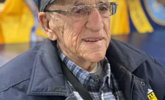 John "Johnny Q" Quinesso Sr., a WWII veteran, smiles during his 100th birthday celebration on Thursday, Feb. 5, 2026 in Camden, N.J., aboard the Battleship New Jersey. (AP Photo/Tassanee Vejpongsa)