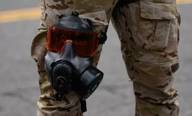 FILE - A gas mask and goggles are seen attached to a Customs and Border Protection officer's leg outside a U.S. Immigration and Customs Enforcement facility, Oct. 4, 2025, in Portland, Ore. (AP Photo/Jenny Kane, File)