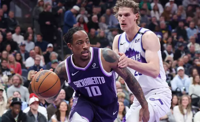 Sacramento Kings guard DeMar DeRozan (10) drives to the basket against Utah Jazz forward Lauri Markkanen, right, during the first half of an NBA basketball game, Wednesday, Feb. 11, 2026, in Salt Lake City. (AP Photo/Rob Gray)