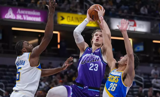 Utah Jazz forward Lauri Markkanen (23) shoots between Indiana Pacers forward Jarace Walker (5) and guard Ben Sheppard (26) during the second half of an NBA basketball game in Indianapolis, Tuesday, Feb. 3, 2026. (AP Photo/Michael Conroy)
