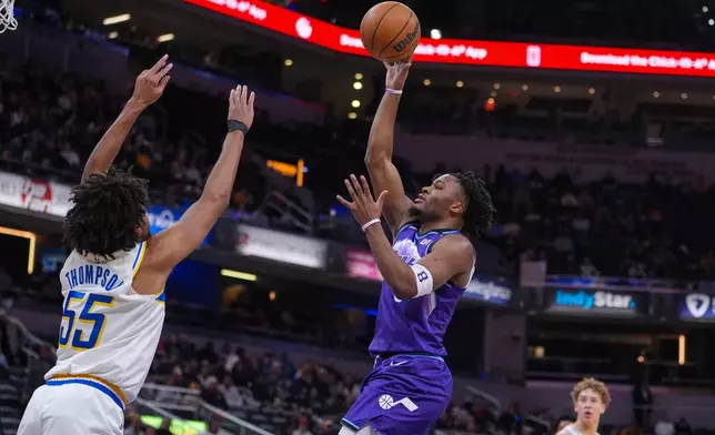 Utah Jazz guard Isaiah Collier (8) shoots over Indiana Pacers guard Ethan Thompson (55) during the second half of an NBA basketball game in Indianapolis, Tuesday, Feb. 3, 2026. (AP Photo/Michael Conroy)