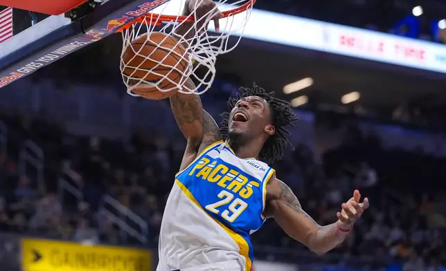 Indiana Pacers guard Quenton Jackson (29) gets a dunk against the Utah Jazz during the second half of an NBA basketball game in Indianapolis, Tuesday, Feb. 3, 2026. (AP Photo/Michael Conroy)