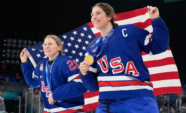 United States' Kendall Coyne, left, and United States' Hilary Knight celebrate after victory ceremony for women's ice hockey at the 2026 Winter Olympics, in Milan, Italy, Thursday, Feb. 19, 2026. (AP Photo/Hassan Ammar)
