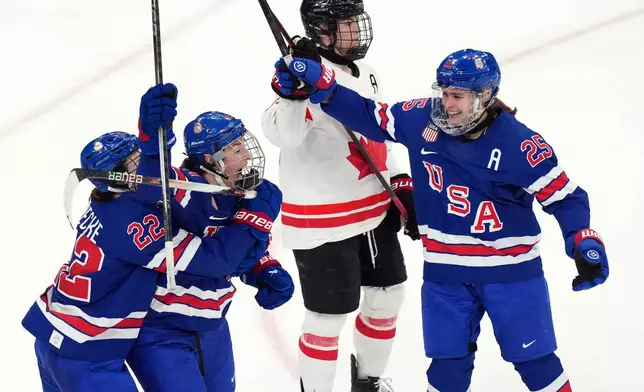 United States' Hilary Knight, second from left, celebrates after scoring a goal against Canada during the third period of the women's ice hockey gold medal game at the 2026 Winter Olympics, in Milan, Italy, Thursday, Feb. 19, 2026. (AP Photo/Carolyn Kaster)