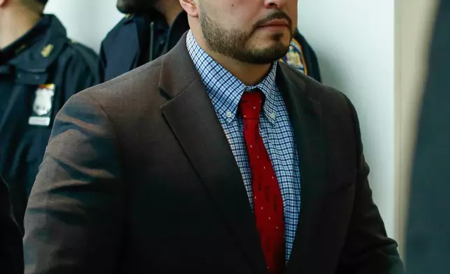 New York police officer Erik Duran who is charged with hurling a plastic cooler at a man fleeing officers on a motorized scooter, causing a crash that killed the driver, arrives to his manslaughter trial at the Bronx Criminal Court in New York, Friday, Feb. 6, 2026. (AP Photo/Kena Betancur)