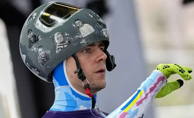 Ukraine's Vladyslav Heraskevych arrives at the finish during a men's skeleton training session at the 2026 Winter Olympics, in Cortina d'Ampezzo, Italy, Tuesday, Feb. 10, 2026. (AP Photo/Alessandra Tarantino)