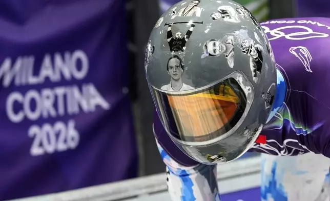 Ukraine's Vladyslav Heraskevych arrives at the finish during a men's skeleton training session at the 2026 Winter Olympics, in Cortina d'Ampezzo, Italy, Tuesday, Feb. 10, 2026. (AP Photo/Alessandra Tarantino)