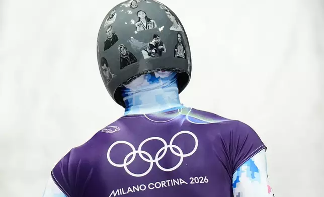 Ukraine's Vladyslav Heraskevych arrives at the finish during a men's skeleton training session at the 2026 Winter Olympics, in Cortina d'Ampezzo, Italy, Tuesday, Feb. 10, 2026. (AP Photo/Alessandra Tarantino)
