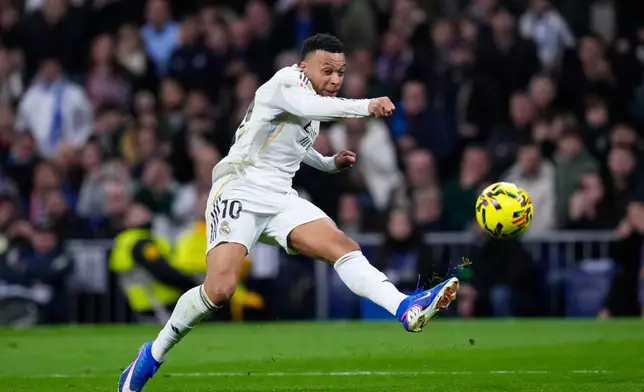 Real Madrid's Kylian Mbappe tries a shot during the Spanish La Liga soccer match between Real Madrid and Rayo Vallecano in Madrid, Spain, Sunday, Feb. 1, 2026. (AP Photo/Manu Fernandez)