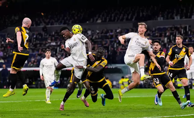 Real Madrid's Vinicius Junior, center left, heads for the ball during the Spanish La Liga soccer match between Real Madrid and Rayo Vallecano in Madrid, Spain, Sunday, Feb. 1, 2026. (AP Photo/Manu Fernandez)