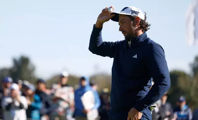 Marco Penge, from England, reacts after putting on the 18th green during the second round of the Genesis Invitational golf tournament at Riviera Country Club, Friday, Feb. 20, 2026, in the Pacific Palisades area of Los Angeles. (AP Photo/Caroline Brehman)