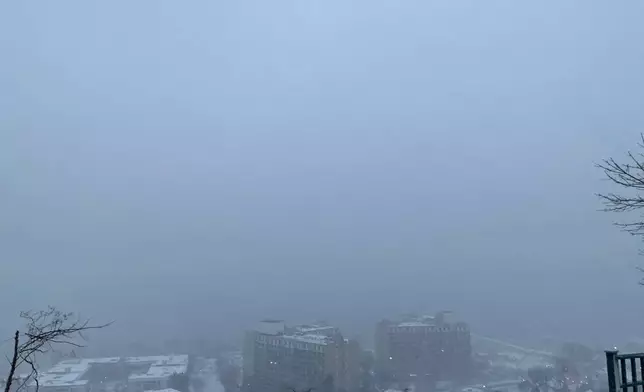 A view from the New Jersey side of the Palisades facing the George Washington Bridge shows a view of the Hudson River with limited visibility during the beginning of an intense winter storm, in Fort Lee, N.J., Sunday, Feb. 22, 2026. (AP Photo/Pablo Salinas)