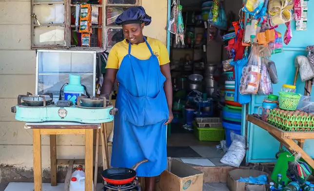 Grace Kathambi uses a KOKO Cooker bioethanol fuel stove to fry and sell French fries at her shop in the Kibera informal settlement on the outskirts of Nairobi, Kenya, Wednesday, Feb. 4, 2026. (AP Photo/Atieno Muyuyi)