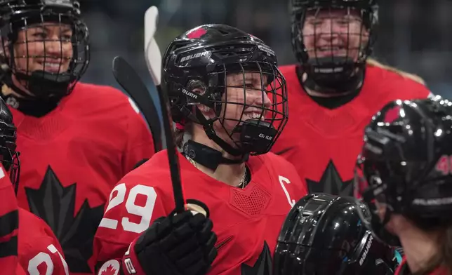 Canada's Marie-Philip Poulin (29) gathers with teammates during warmups before a preliminary round match of women's ice hockey against Czechia at the 2026 Winter Olympics, in Milan, Italy, Monday, Feb. 9, 2026. (AP Photo/Carolyn Kaster)